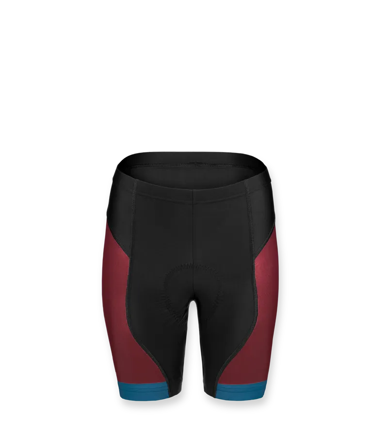 Un pantalón corto de ciclismo para mujer de owayo en negro con paneles laterales rojos y detalles azules en el dobladillo.